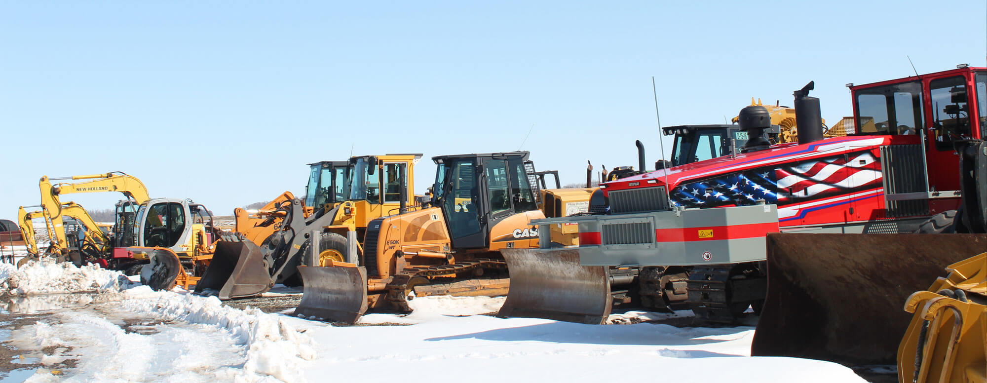 Row of Dahle Enterprises' excavating equipment in winter