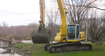 Large Excavator lifing its bucket | Excavating Services